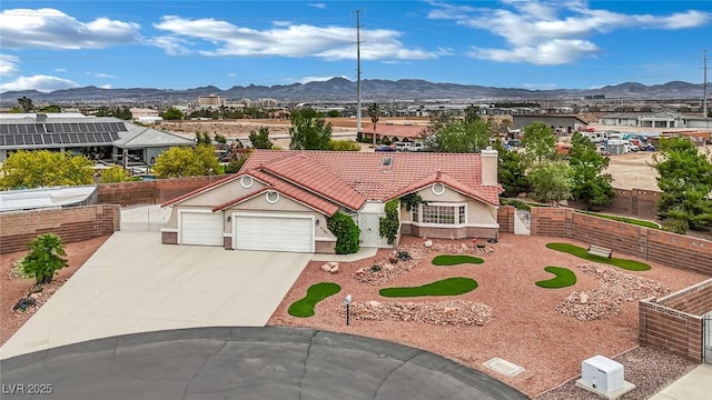 9180 Mohawk St, Las Vegas, NV 89139 - view of front of home with a mountain view, an attached garage, concrete driveway, and stucco siding