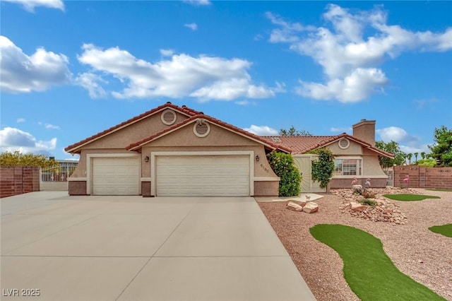 9180 Mohawk St, Las Vegas, NV 89139 - single story home with stucco siding, an attached garage, driveway, a chimney, and a tile roof