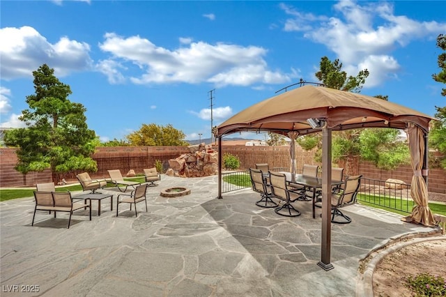 9180 Mohawk St, Las Vegas, NV 89139 - fenced backyard featuring a gazebo, an outdoor fire pit, a patio area, and outdoor dining area