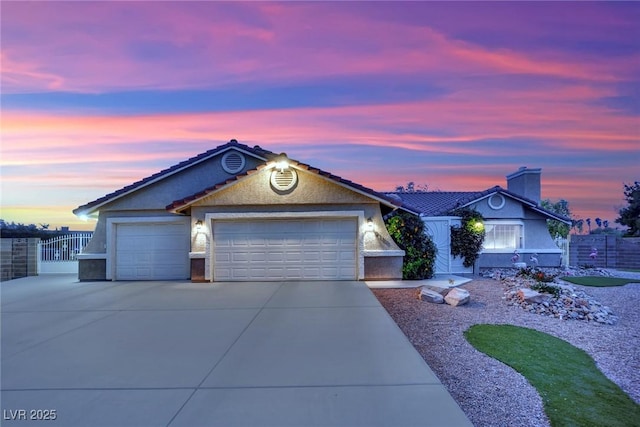 9180 Mohawk St, Las Vegas, NV 89139 - ranch-style house featuring concrete driveway, an attached garage, stucco siding, and a chimney