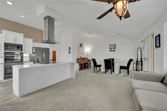 9180 Mohawk St, Las Vegas, NV 89139 - kitchen with appliances with stainless steel finishes, island range hood, a ceiling fan, white cabinetry, and light countertops