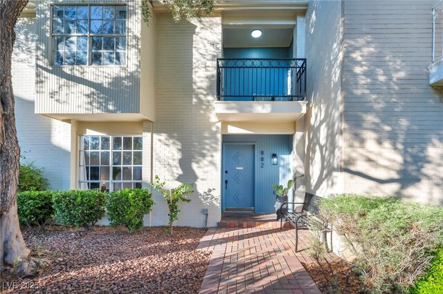 882 Tam O Shanter, Las Vegas, NV 89109 - view of exterior entry with a balcony and brick siding