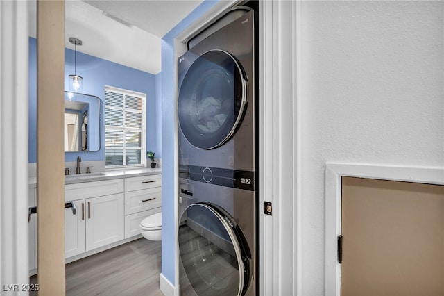 882 Tam O Shanter, Las Vegas, NV 89109 - laundry area with estacked washer and dryer and light wood-style floors