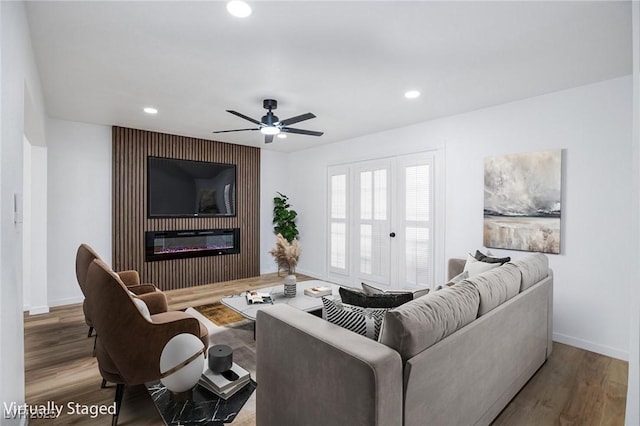 572 Tam O Shanter, Las Vegas, NV 89109 - living room featuring recessed lighting, wood finished floors, a glass covered fireplace, and a ceiling fan