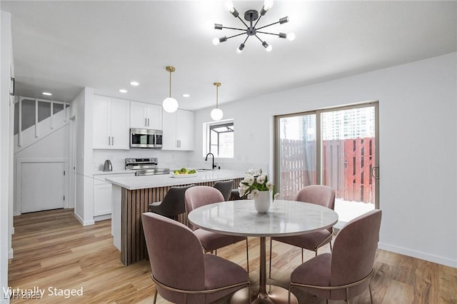 572 Tam O Shanter, Las Vegas, NV 89109 - dining space featuring light wood finished floors, stairway, a chandelier, and recessed lighting