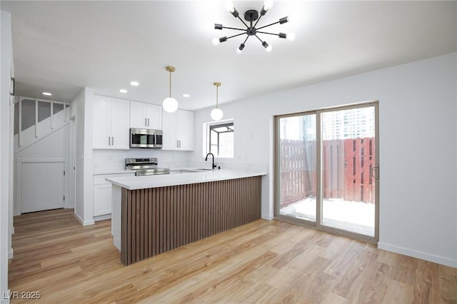 572 Tam O Shanter, Las Vegas, NV 89109 - kitchen with appliances with stainless steel finishes, light wood-type flooring, a chandelier, white cabinets, and recessed lighting