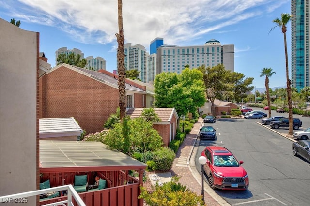 572 Tam O Shanter, Las Vegas, NV 89109 - view of building exterior with uncovered parking and a city view