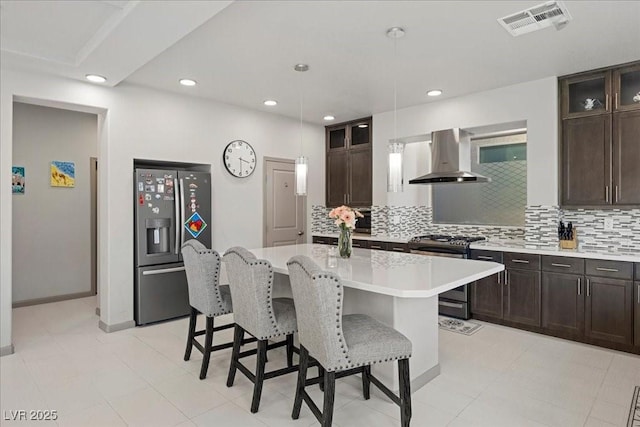 6618 Tangled Vines Ave, Las Vegas, NV 89139 - kitchen featuring wall chimney range hood, appliances with stainless steel finishes, light countertops, backsplash, and recessed lighting