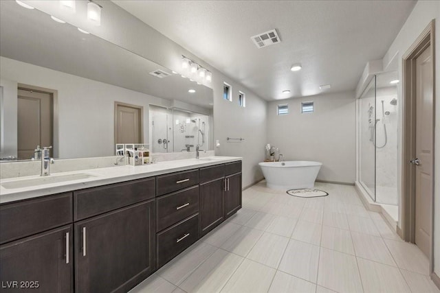 6618 Tangled Vines Ave, Las Vegas, NV 89139 - bathroom featuring a stall shower, double vanity, a soaking tub, and tile patterned floors