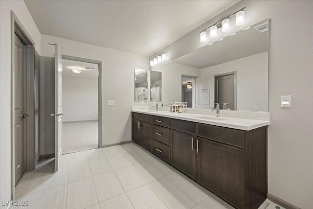 6618 Tangled Vines Ave, Las Vegas, NV 89139 - bathroom with double vanity and baseboards