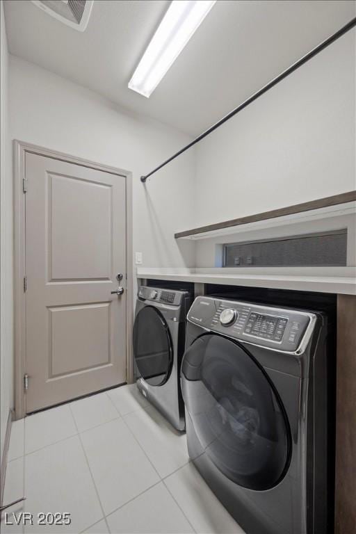 6618 Tangled Vines Ave, Las Vegas, NV 89139 - laundry area with washer and clothes dryer and light tile patterned floors