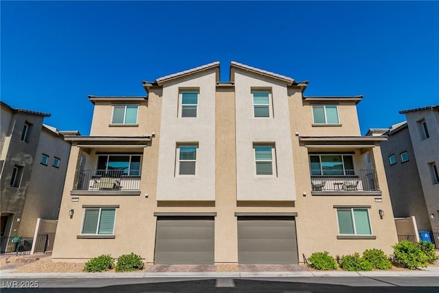 6953 Midnight Bronze St, North Las Vegas, NV 89086 - view of building exterior with a garage and driveway
