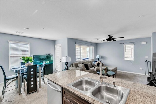 6953 Midnight Bronze St, North Las Vegas, NV 89086 - kitchen featuring stainless steel dishwasher, open floor plan, a ceiling fan, and light carpet