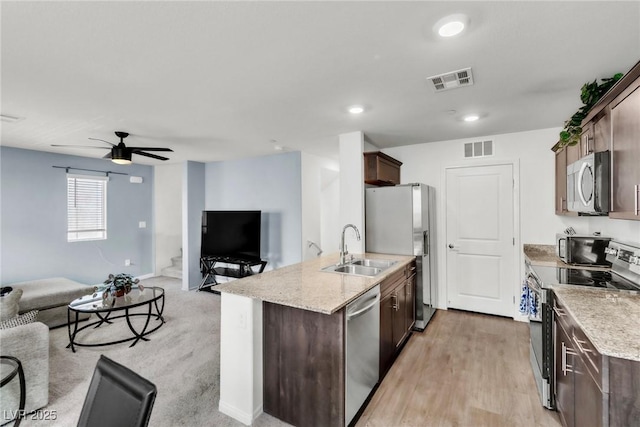 6953 Midnight Bronze St, North Las Vegas, NV 89086 - kitchen with stainless steel appliances, open floor plan, dark brown cabinetry, a ceiling fan, and recessed lighting