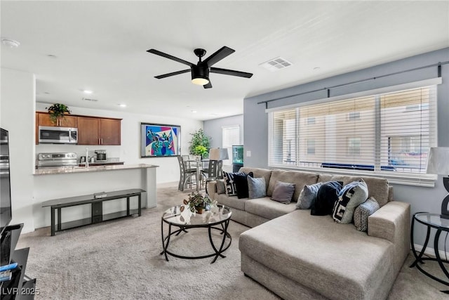 6953 Midnight Bronze St, North Las Vegas, NV 89086 - living area featuring ceiling fan and light carpet