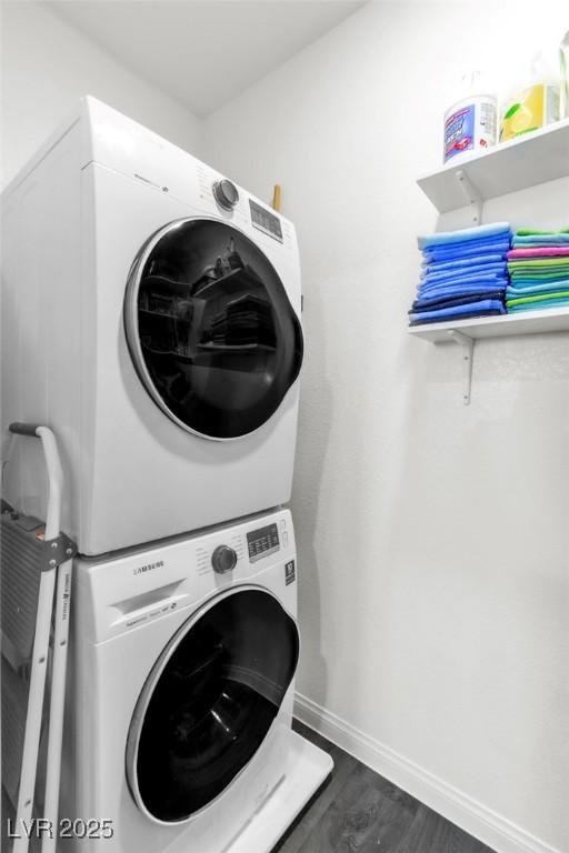 6953 Midnight Bronze St, North Las Vegas, NV 89086 - laundry room featuring stacked washer / dryer and dark wood-style flooring
