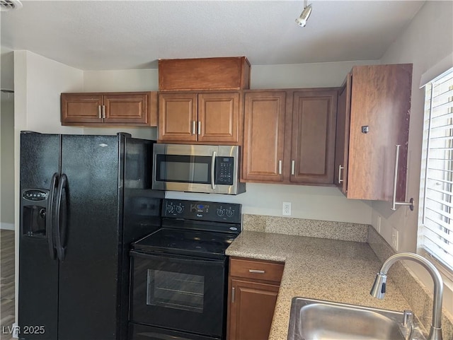 1220 Toledo St, Henderson, NV 89015 - kitchen featuring black appliances and brown cabinets