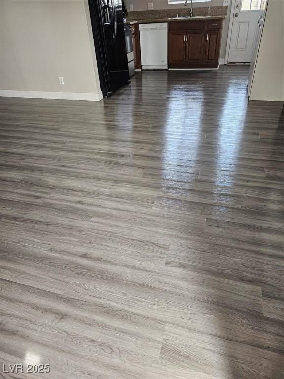 1220 Toledo St, Henderson, NV 89015 - detailed view of dishwasher, dark wood-style floors, freestanding refrigerator, and dark countertops
