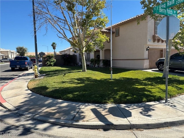 6363 Berry Patch Way, Las Vegas, NV 89142 - view of side of property with an attached garage, stucco siding, a yard, and a tiled roof