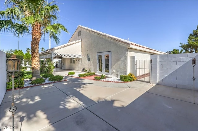 5425 Thomaston Ct, Las Vegas, NV 89122 - back of house featuring a gate, stucco siding, and a patio