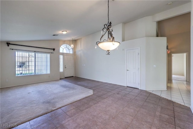 5425 Thomaston Ct, Las Vegas, NV 89122 - tiled empty room with high vaulted ceiling and carpet floors