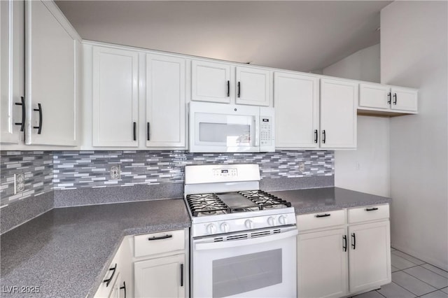 5425 Thomaston Ct, Las Vegas, NV 89122 - kitchen with white appliances, white cabinetry, backsplash, dark countertops, and light tile patterned floors