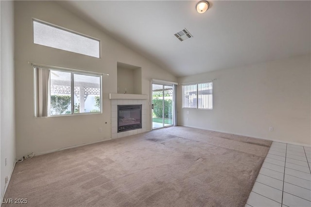 5425 Thomaston Ct, Las Vegas, NV 89122 - unfurnished living room featuring lofted ceiling, a tile fireplace, carpet floors, and tile patterned floors