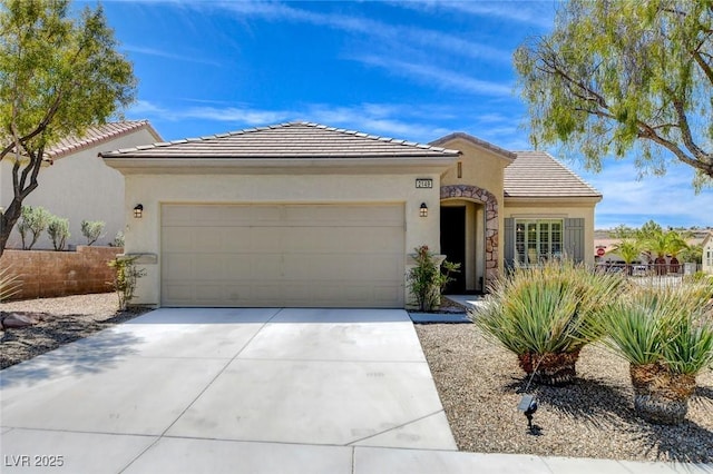 2149 Kelsey Creek Ct, Henderson, NV 89044 - view of front facade featuring a garage, concrete driveway, a tile roof, and stucco siding