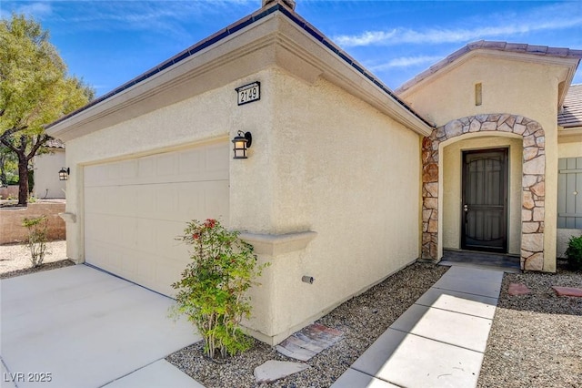 2149 Kelsey Creek Ct, Henderson, NV 89044 - view of exterior entry featuring stucco siding, an attached garage, driveway, and stone siding