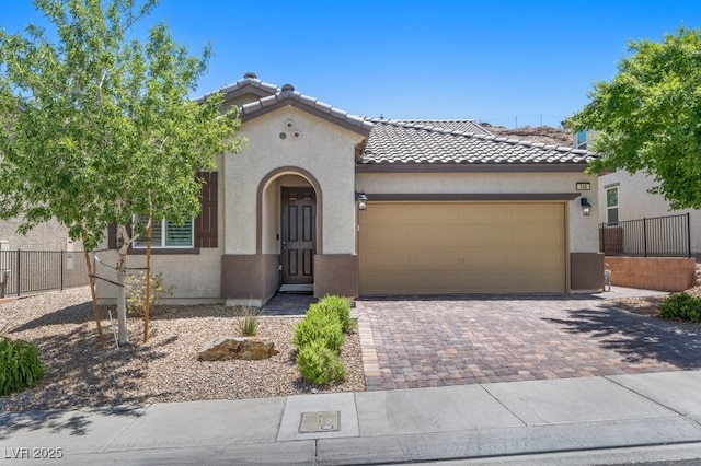 145 Langley Hill Ave, Henderson, NV 89002 - mediterranean / spanish-style home featuring stucco siding, a garage, decorative driveway, and a tile roof