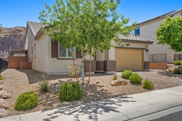 145 Langley Hill Ave, Henderson, NV 89002 - view of front of house featuring a tile roof, stucco siding, and an attached garage