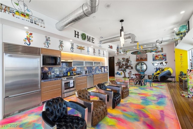 200 Hoover Ave Unit 1813, Las Vegas, NV 89101 - kitchen featuring built in appliances, tasteful backsplash, hardwood / wood-style floors, and under cabinet range hood