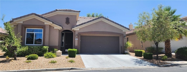 7395 Howell Mill Ct, Las Vegas, NV 89113 - view of front facade with an attached garage, stucco siding, driveway, and a tiled roof
