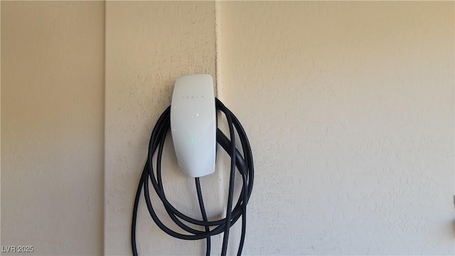 145 Forest Crossing Ct, Las Vegas, NV 89148 - garage view of electric vehicle charger and stucco siding