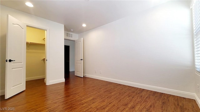 145 Forest Crossing Ct, Las Vegas, NV 89148 - unfurnished bedroom featuring wood finished floors, a spacious closet, recessed lighting, multiple windows, and a closet