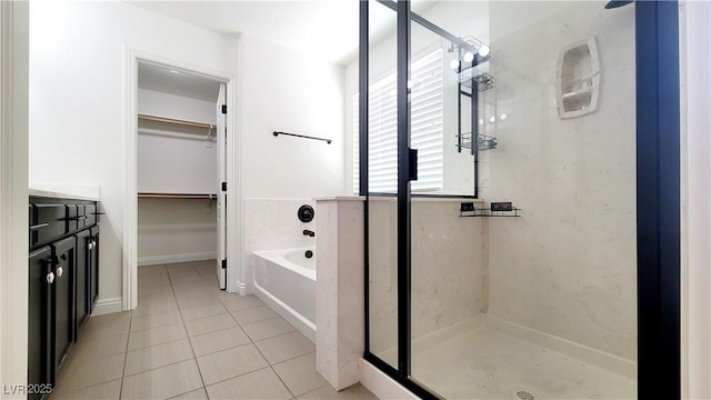 145 Forest Crossing Ct, Las Vegas, NV 89148 - full bath featuring a stall shower, tile patterned flooring, a bath, and a spacious closet