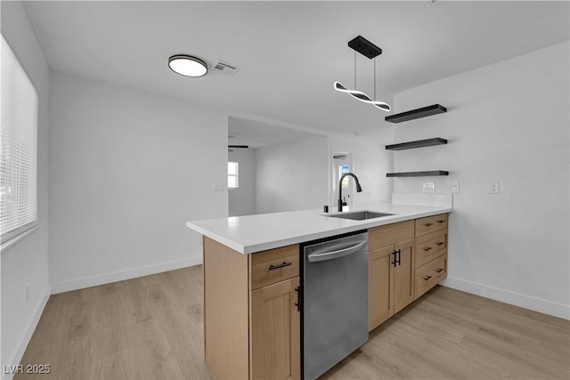 1108 Putnam Ave, North Las Vegas, NV 89030 - kitchen with dishwasher, light wood finished floors, light countertops, and a peninsula