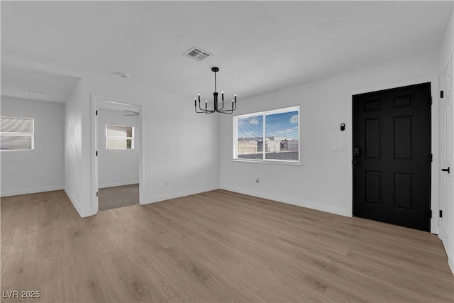 1108 Putnam Ave, North Las Vegas, NV 89030 - unfurnished dining area with a chandelier and light wood-type flooring
