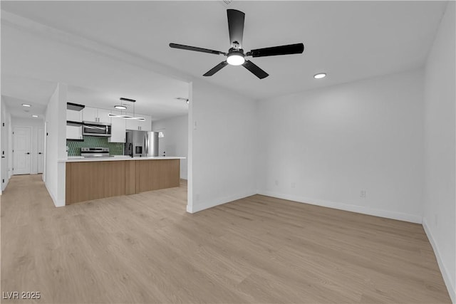 1108 Putnam Ave, North Las Vegas, NV 89030 - unfurnished living room with ceiling fan, light wood-type flooring, and recessed lighting