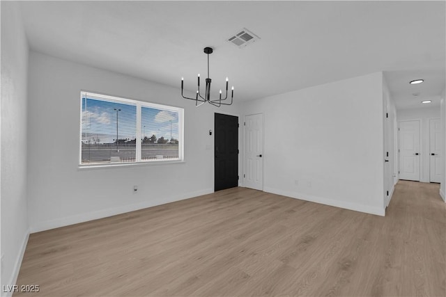 1108 Putnam Ave, North Las Vegas, NV 89030 - empty room with a chandelier, light wood finished floors, and recessed lighting
