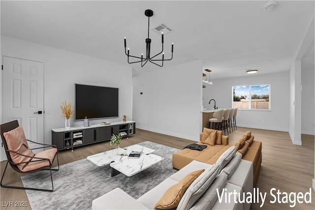 1108 Putnam Ave, North Las Vegas, NV 89030 - living room featuring a chandelier and wood finished floors