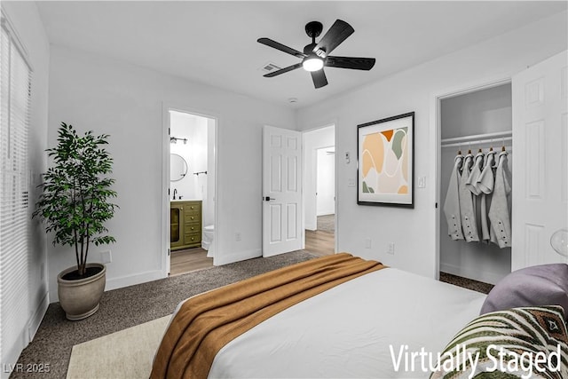 1108 Putnam Ave, North Las Vegas, NV 89030 - bedroom featuring carpet flooring, a spacious closet, ensuite bath, a ceiling fan, and a closet