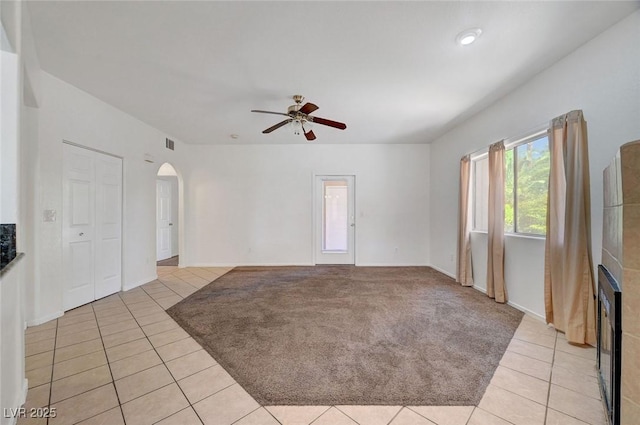 900 Heavenly Hills Ct Unit 114, Las Vegas, NV 89145 - unfurnished living room featuring light tile patterned flooring, arched walkways, and a ceiling fan