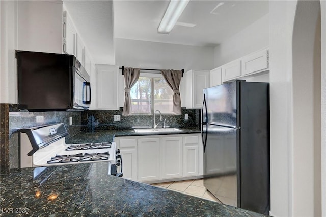 900 Heavenly Hills Ct Unit 114, Las Vegas, NV 89145 - kitchen with black appliances, tasteful backsplash, white cabinetry, and dark stone countertops