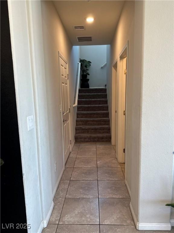 7636 Bandon Cliffs St, North Las Vegas, NV 89084 - hallway with light tile patterned flooring and stairs