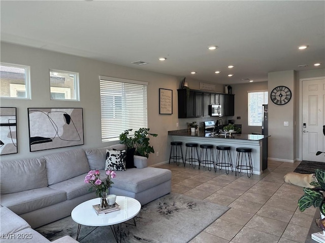 7636 Bandon Cliffs St, North Las Vegas, NV 89084 - living area featuring light tile patterned floors and recessed lighting