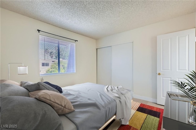 4683 Monterey Cir Unit 4, Las Vegas, NV 89169 - bedroom with a closet, a textured ceiling, and wood finished floors