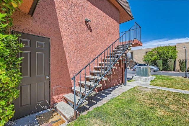 4683 Monterey Cir Unit 4, Las Vegas, NV 89169 - entrance to property with stucco siding and a yard