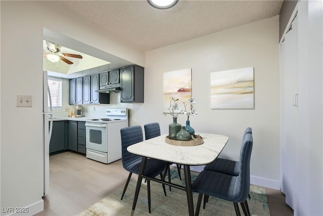 4683 Monterey Cir Unit 4, Las Vegas, NV 89169 - dining space with light wood finished floors, a ceiling fan, and a textured ceiling