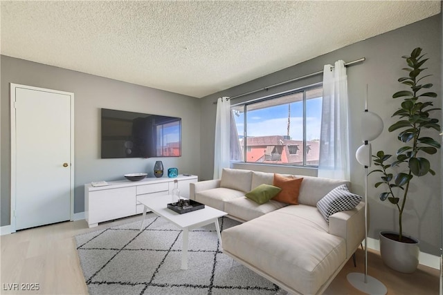 4683 Monterey Cir Unit 4, Las Vegas, NV 89169 - living room featuring a textured ceiling and light wood-type flooring